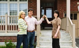 Happy couple with real estate agent
